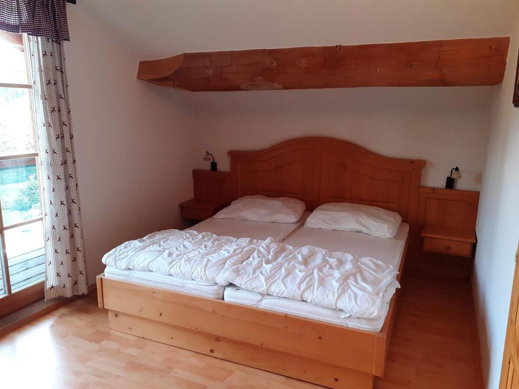 a bedroom with a large bed with a wooden headboard at Schönberghütte in Lachtal