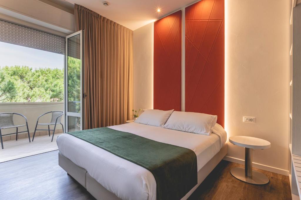 Postel nebo postele na pokoji v ubytování Hotel Loretta & Dependance