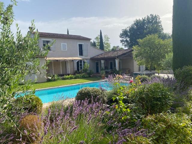 a house with a swimming pool in a yard at Mas des IRIS in Saint-Rémy-de-Provence