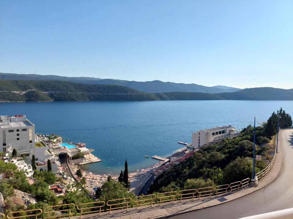 a view of a body of water next to a road at Apartments Menalo in Neum