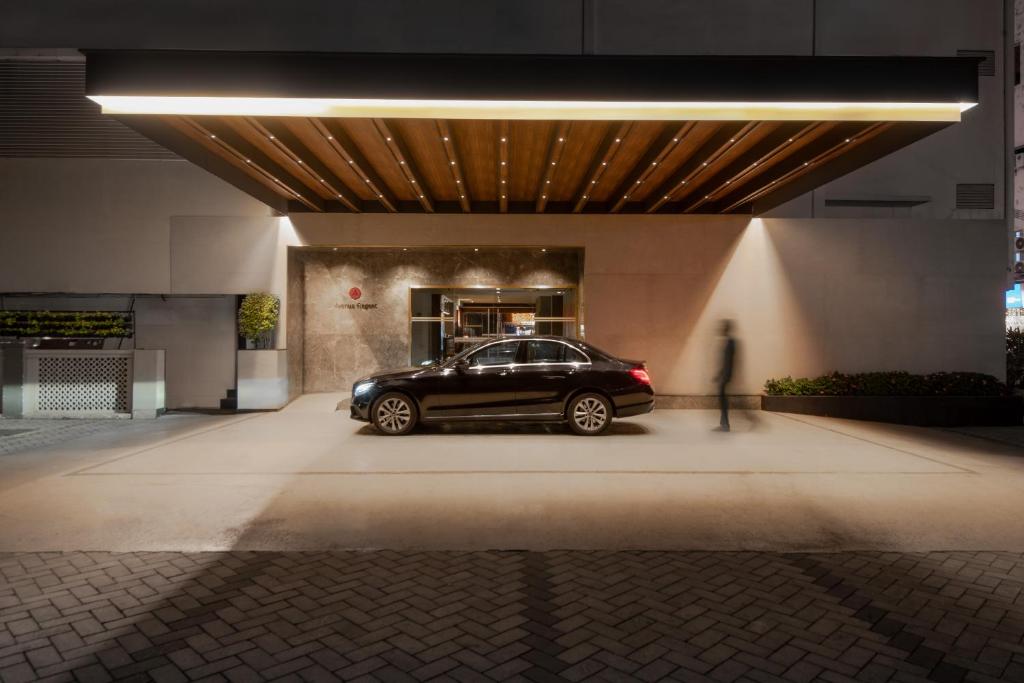 a black car parked in front of a building at The Avenue Regent in Cochin