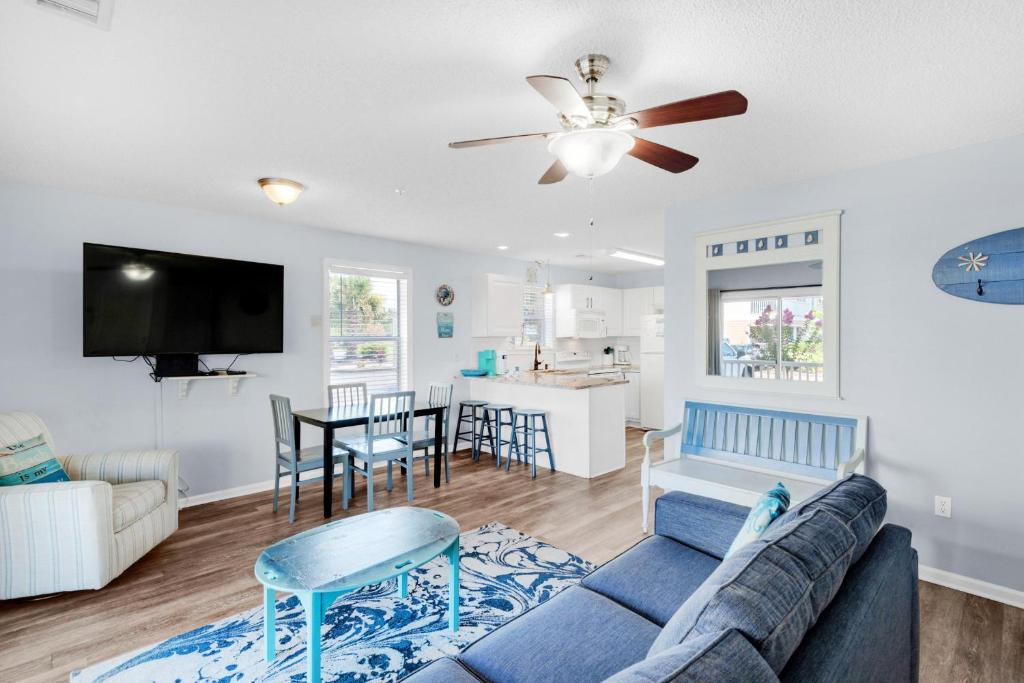 a living room with a couch and a table at St. Martin Beachwalk Villas 111 in Destin