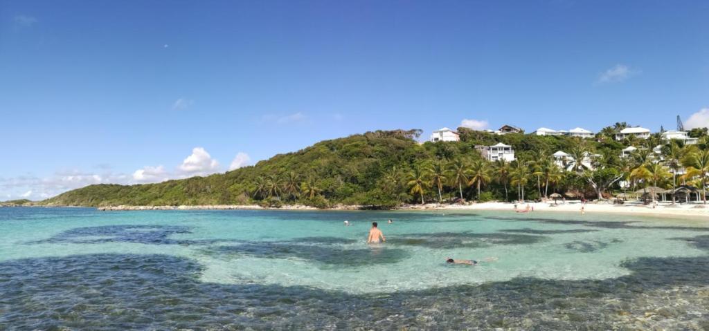 a group of people in the water at a beach at Boheme 4 personnes ( 2 chambres ) in Saint-François