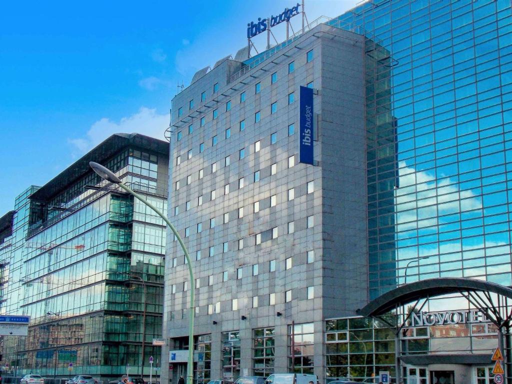 a large building with a clock on the top of it at ibis budget Porte D'Orleans in Paris