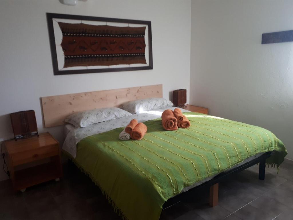 Łóżko lub łóżka w pokoju w obiekcie La Collina Olistica