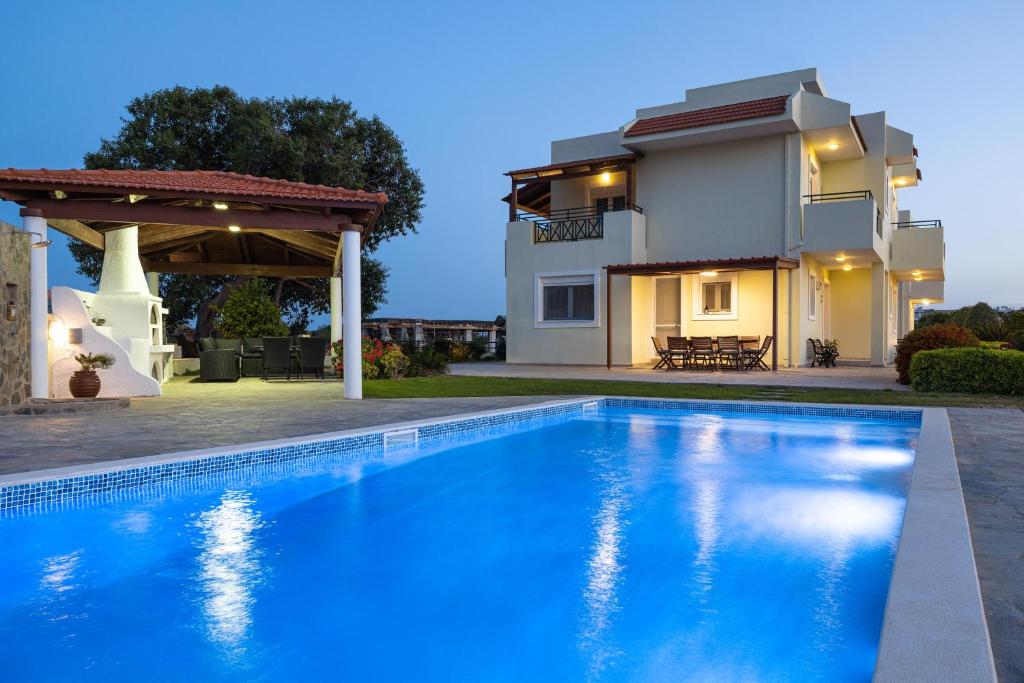 Villa con piscina frente a una casa en Amphitrite Villa, en Gennadi