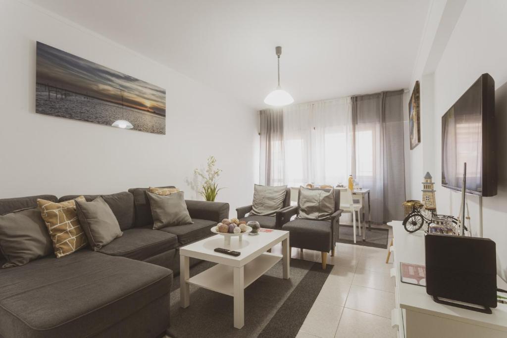 a living room with a couch and a table at Best Houses 20 - Lovely Apartament - Peniche in Peniche