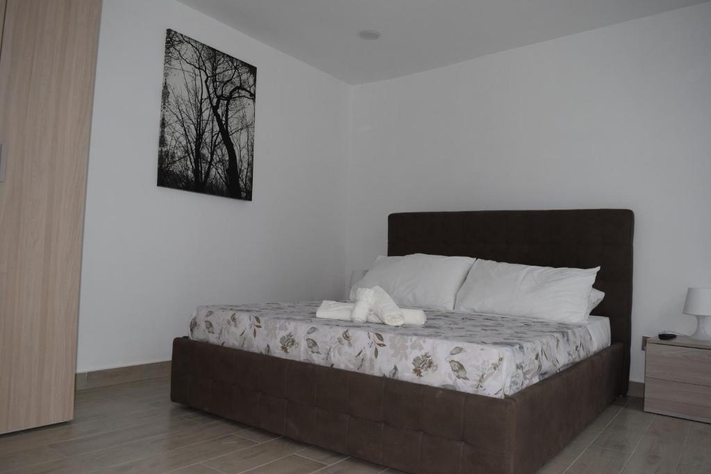a bed in a bedroom with a picture on the wall at Dimora D’alessandro in Naples
