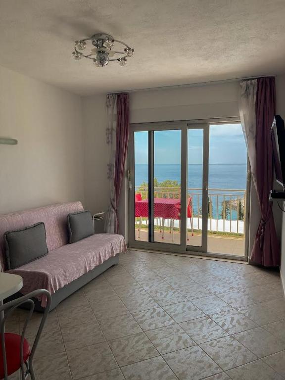 a living room with a couch and a view of the ocean at Apartments Marija Magdalena in Hvar
