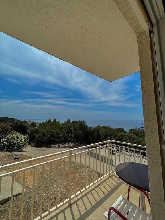 a balcony with a table and chairs on a balcony at Apartments Marija Magdalena in Hvar