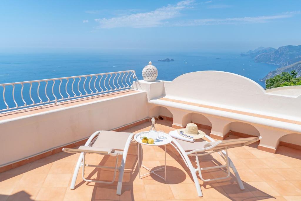 a balcony with a table and chairs and the ocean at Casa Lalù - Rustic apartment with stunning views in Positano