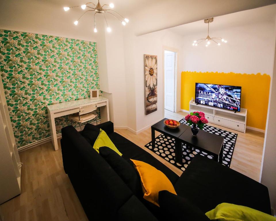 a living room with a couch and a tv at Comfort & Style - KISELEFF - ARCUL DE TRIUMF - in Bucharest