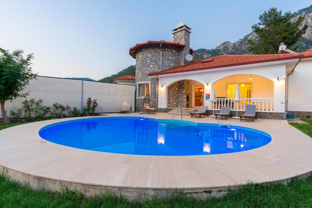 a swimming pool in the backyard of a house at Villa Hill 2 in Dalaman