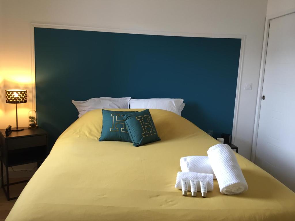 a bedroom with a bed with two towels on it at Agréable maison neuve Angers Centre-Madeleine in Angers