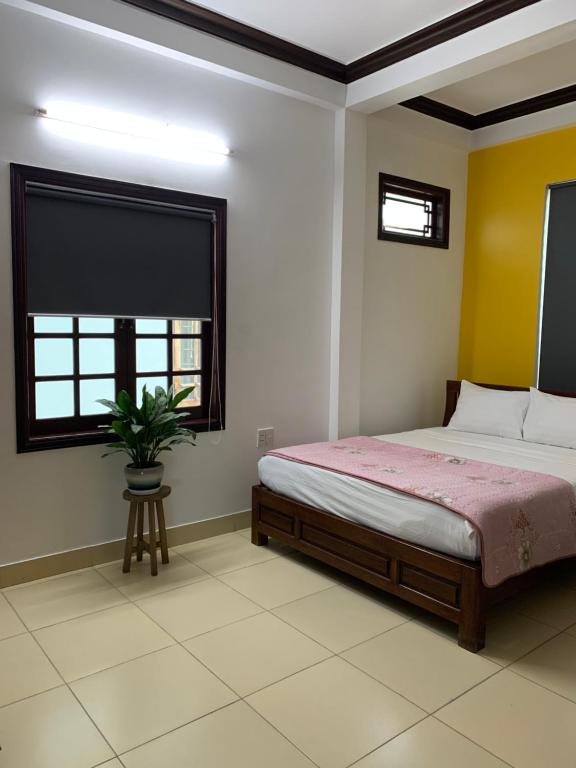 Postel nebo postele na pokoji v ubytování Cheerful Hoi An Hostel