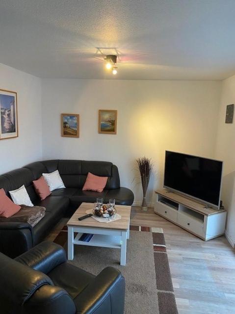 a living room with a couch and a flat screen tv at Wohnung Jolmes in Dahme