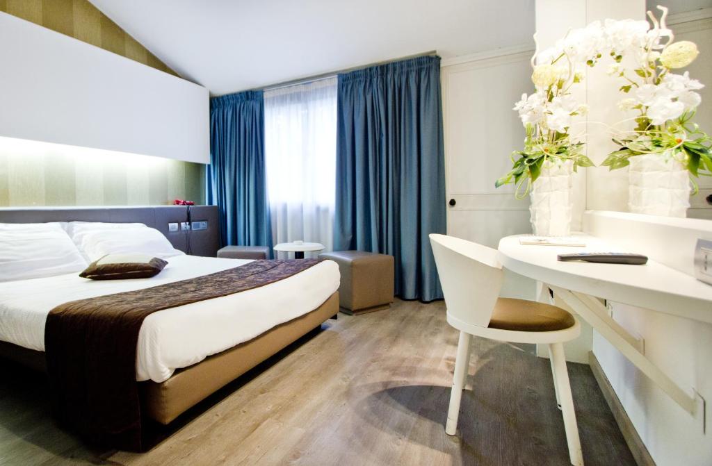 Habitación de hotel con cama y escritorio en Green Hotel Motel, en Vergiate