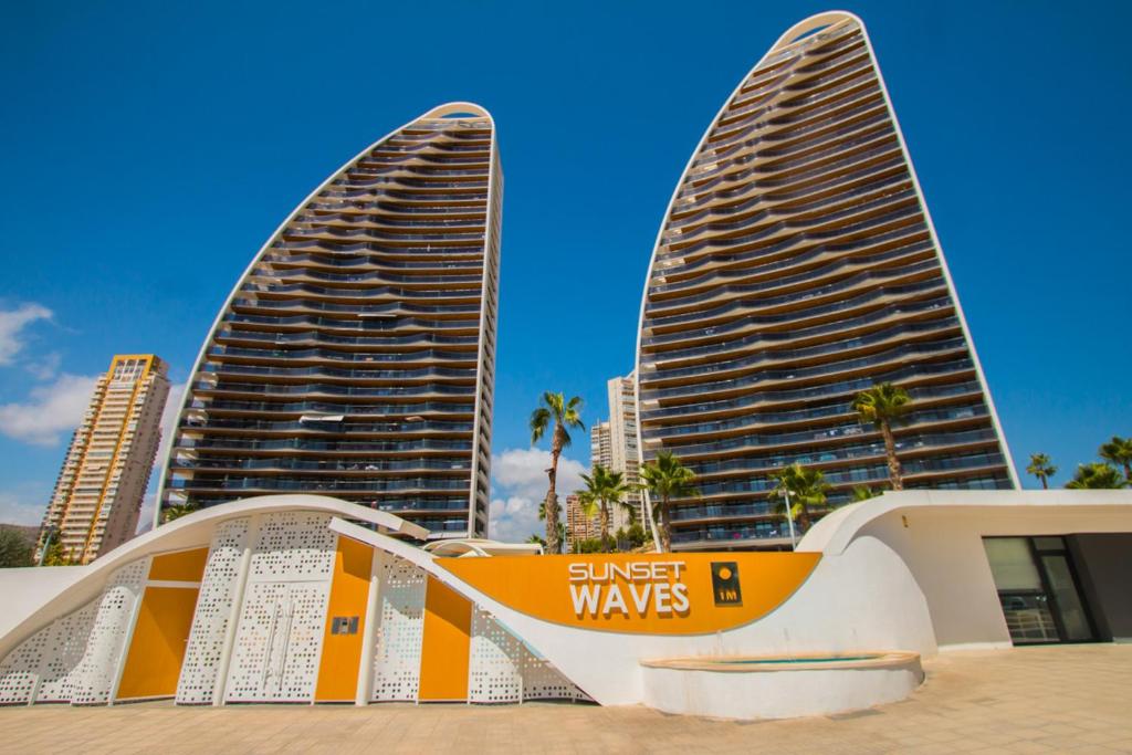 two tall buildings in front of a city at Waves apartment - relax in Costa Blanca in Benidorm