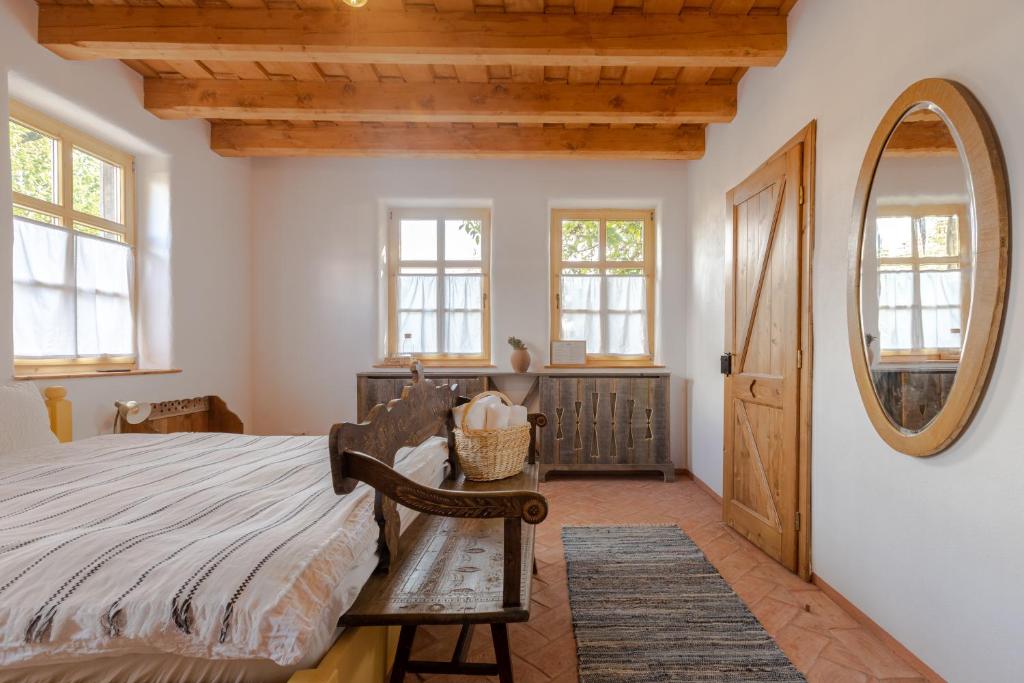 ein Schlafzimmer mit einem großen Bett und einem Spiegel in der Unterkunft Viscri 32 - White Barn and Blue House in Viscri