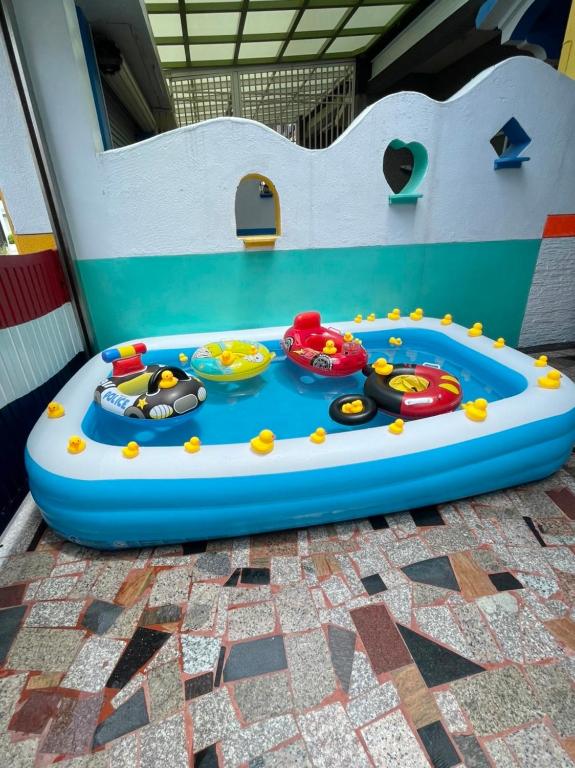 a childs pool in a play room with two toys at Edinburgh 16 Inn in Hengchun