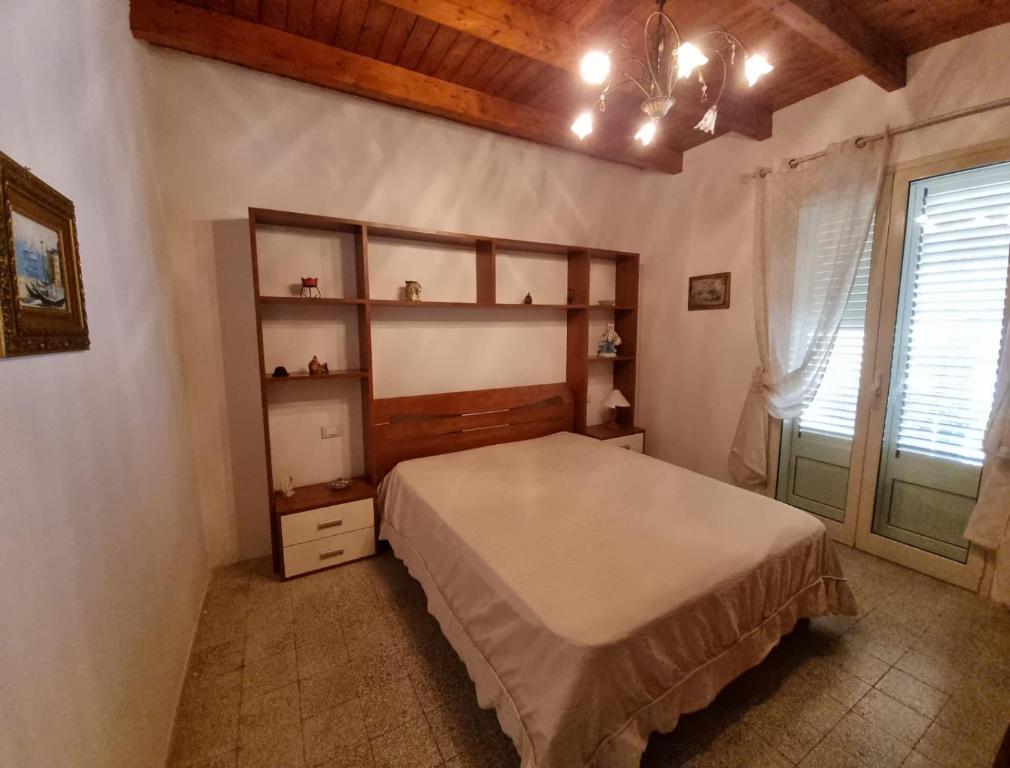 Ένα ή περισσότερα κρεβάτια σε δωμάτιο στο Casa del Pescatore