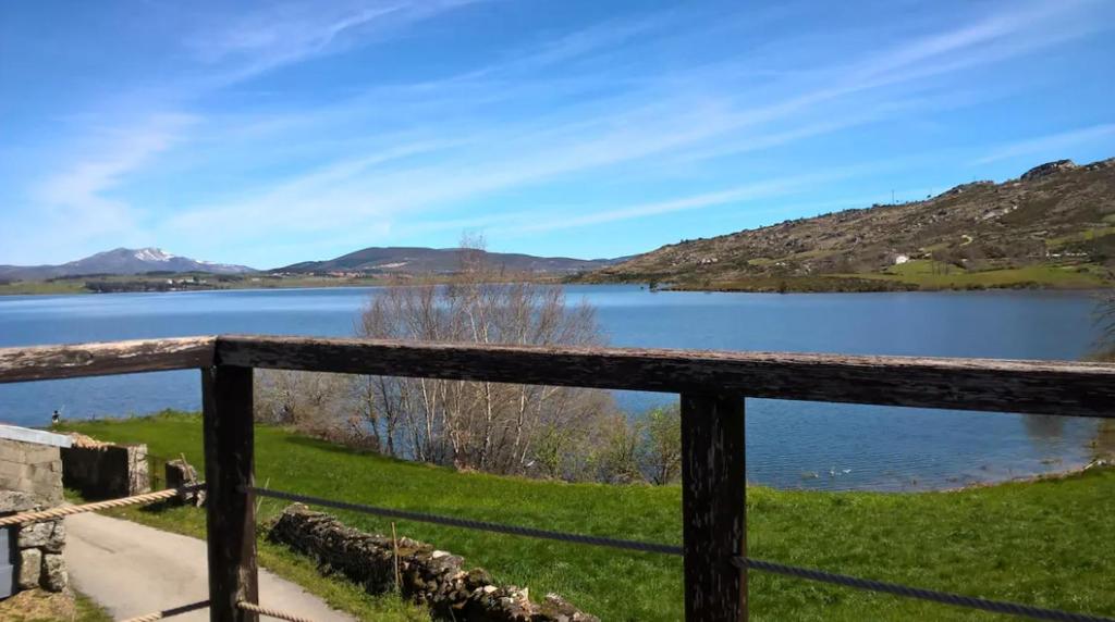 a view of a lake from a wooden fence at Casa do Curral in Negrões