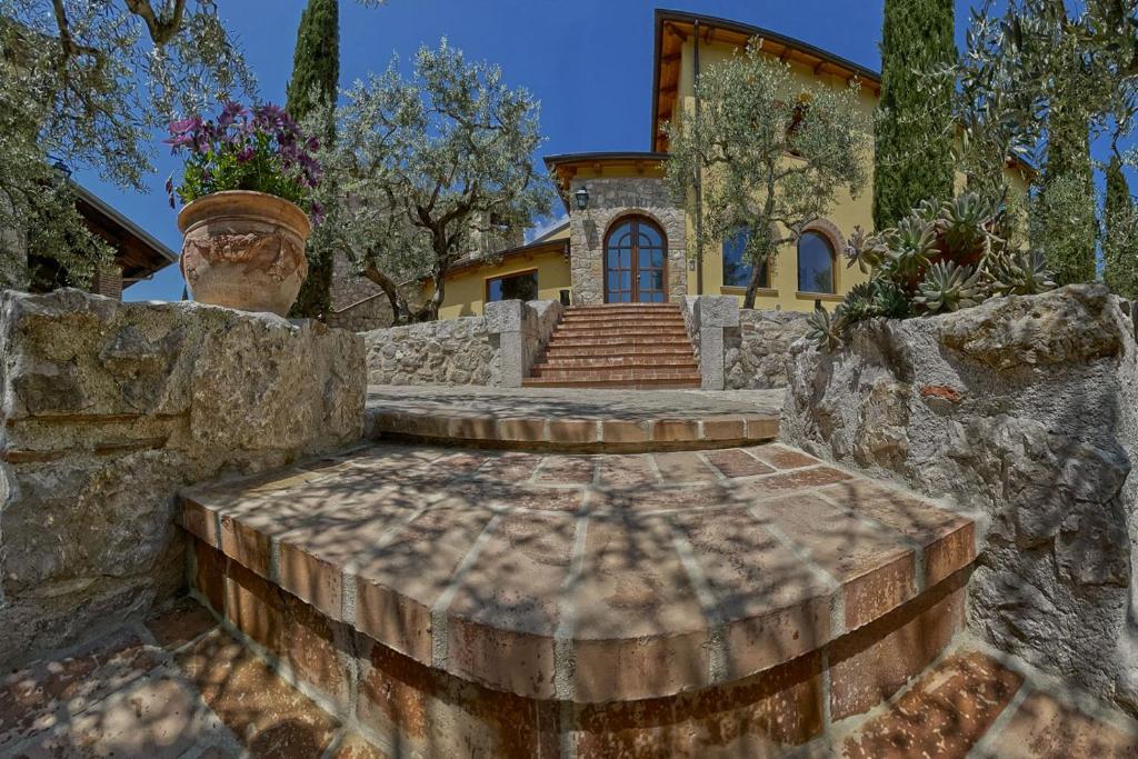 a house with a stone staircase in front of a house at Resort Agriturismo Maliandi in San Rufo