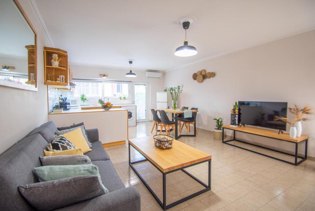 a living room with a couch and a table at Arioso apartment in the center of Zakynthos town in Zakynthos Town