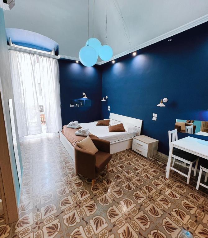 a bedroom with a bed and a blue wall at DEAS B&amp;B in Trani