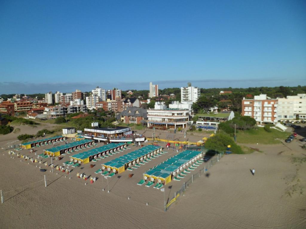 uma vista aérea de uma grande piscina com guarda-sóis e cadeiras em Complejo Turístico CapArcona em Villa Gesell