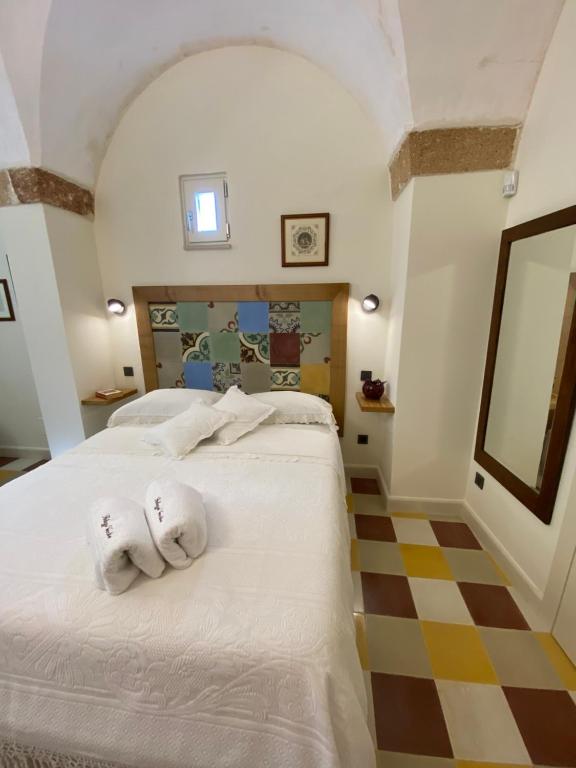 Postel nebo postele na pokoji v ubytování Palazzo Vecchio Cocumola
