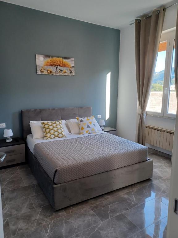a bedroom with a bed and a large window at Adelina House in La Spezia