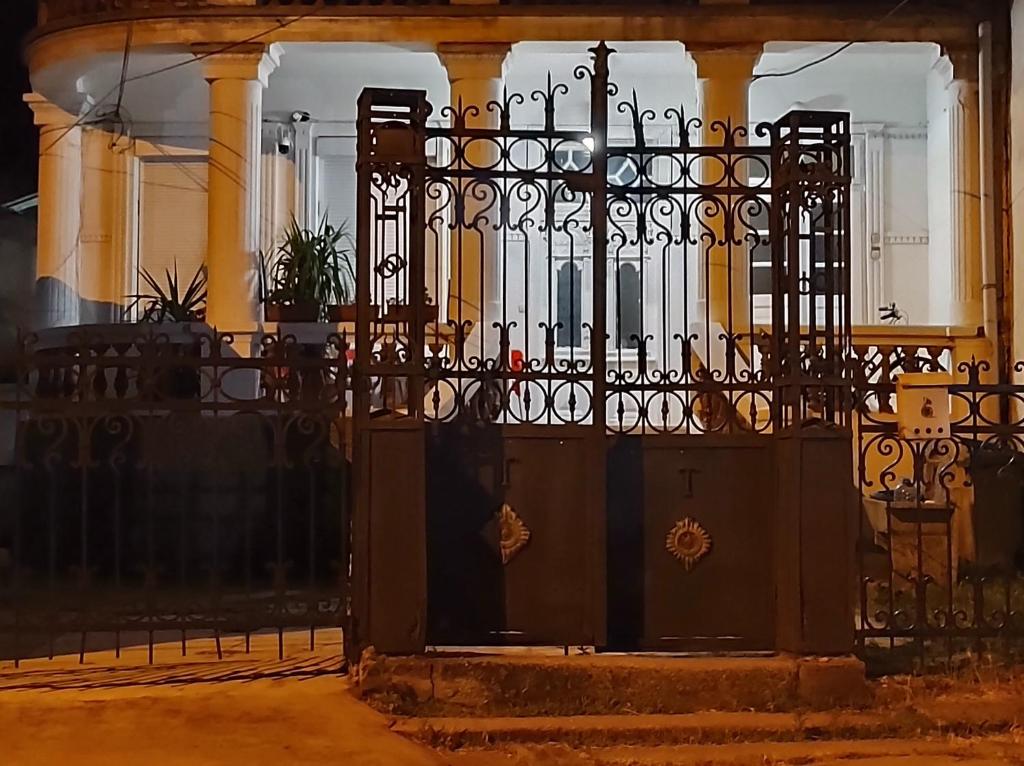 a black gate in front of a building at Guest House Prilep in Prilep