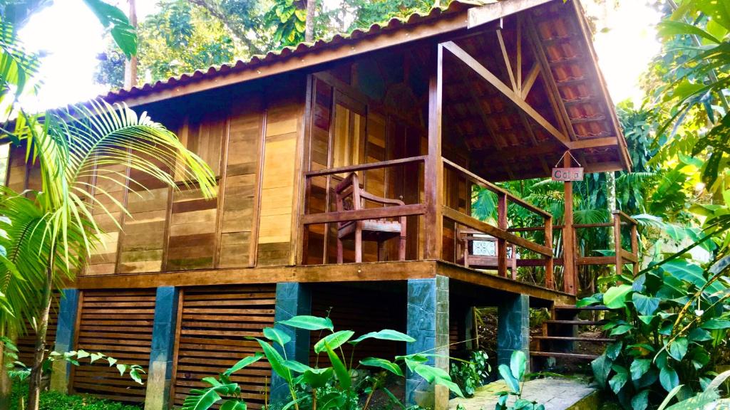 a wooden house in the middle of a forest at Pousada Recanto Afetivo in Trindade