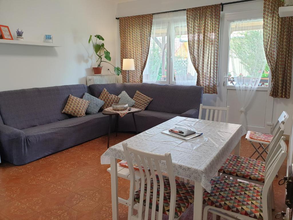 a living room with a blue couch and a table at Sophie Apartment in Balatonberény