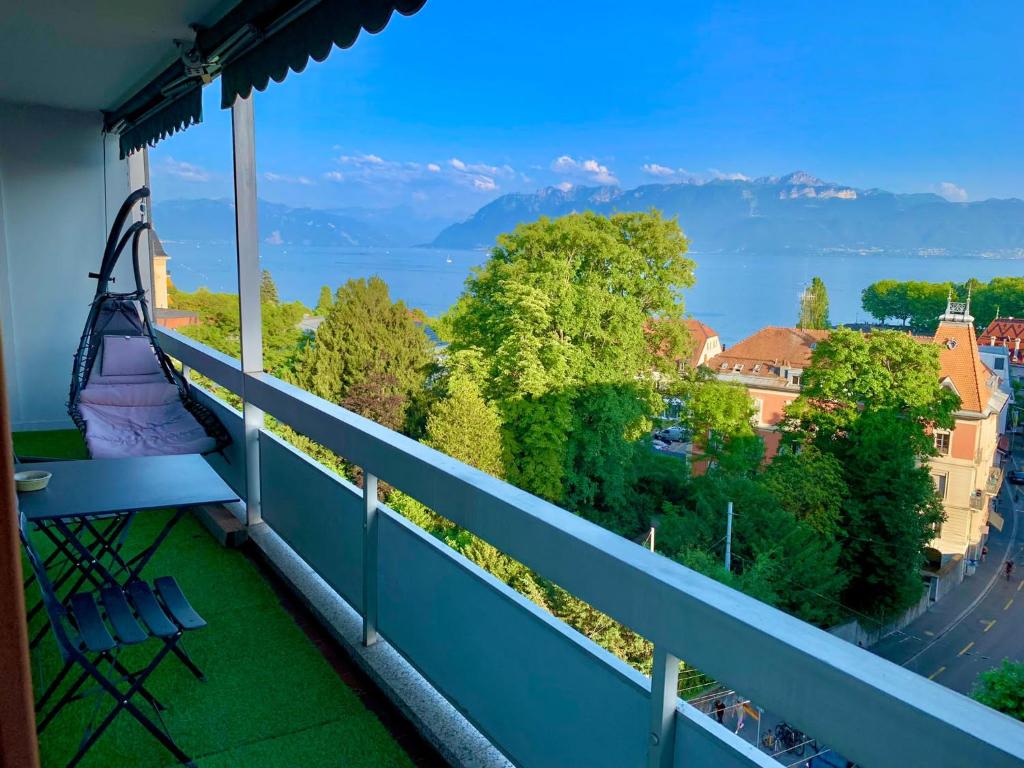 a balcony with a view of the lake and mountains at High standing apartment in Ouchy - Lausanne in Lausanne