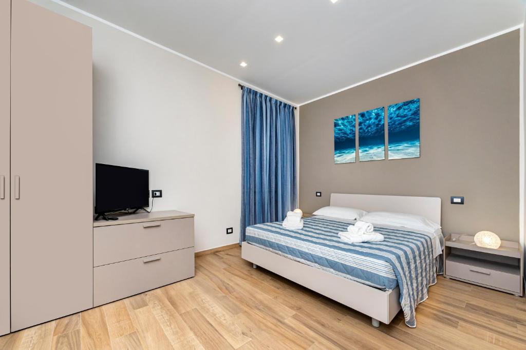 ein Schlafzimmer mit einem Bett und einem Flachbildfernseher in der Unterkunft Casa marina in Genua