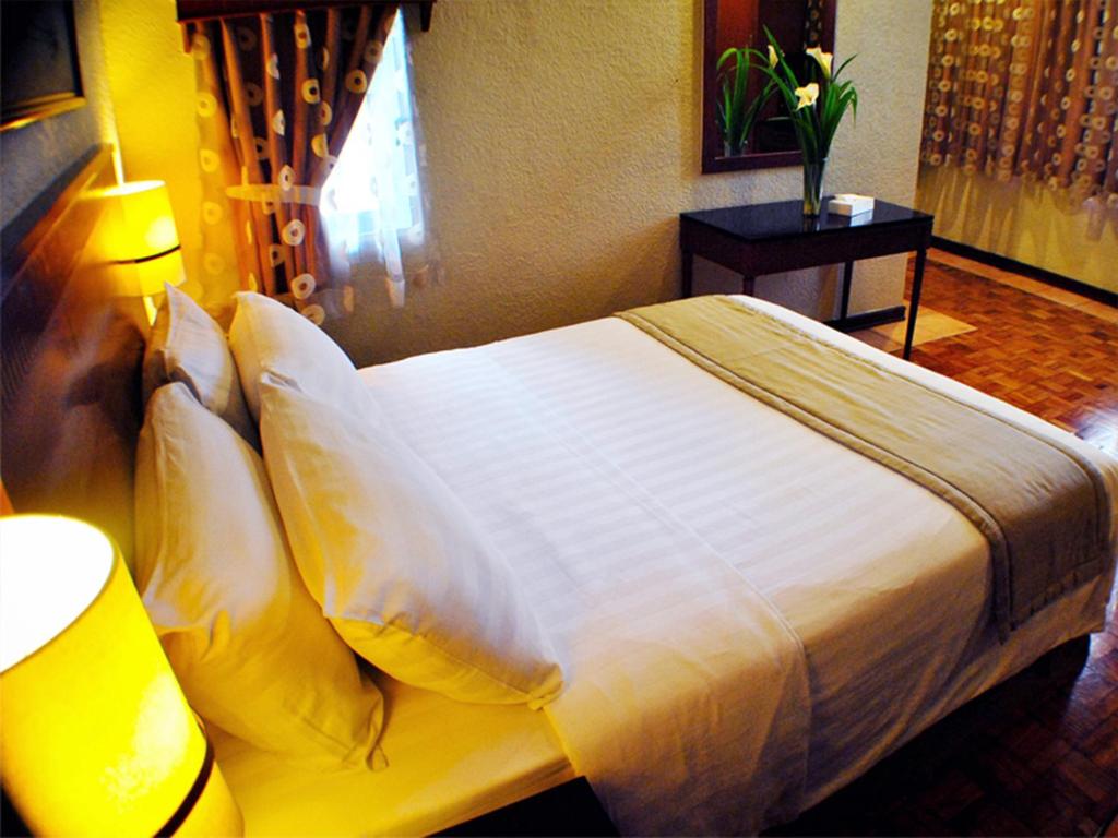 Postel nebo postele na pokoji v ubytování Fersal Hotel - P. Tuazon Cubao
