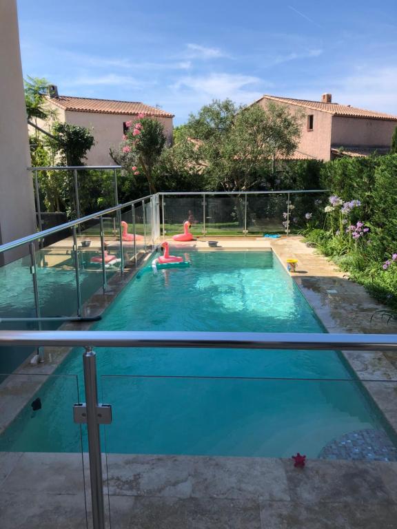 a large swimming pool with people in the water at Villa Elimia in Antibes