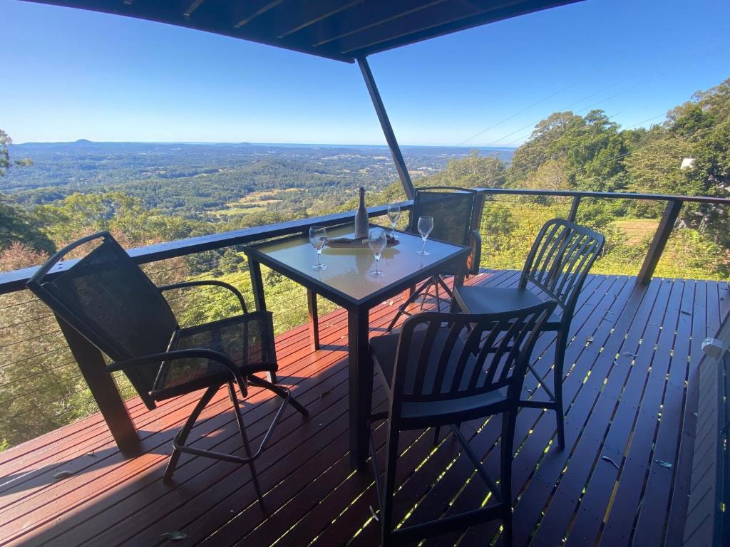 a table and chairs on a deck with a view at IT’S ALL ABOUT THE VIEWS in Montville