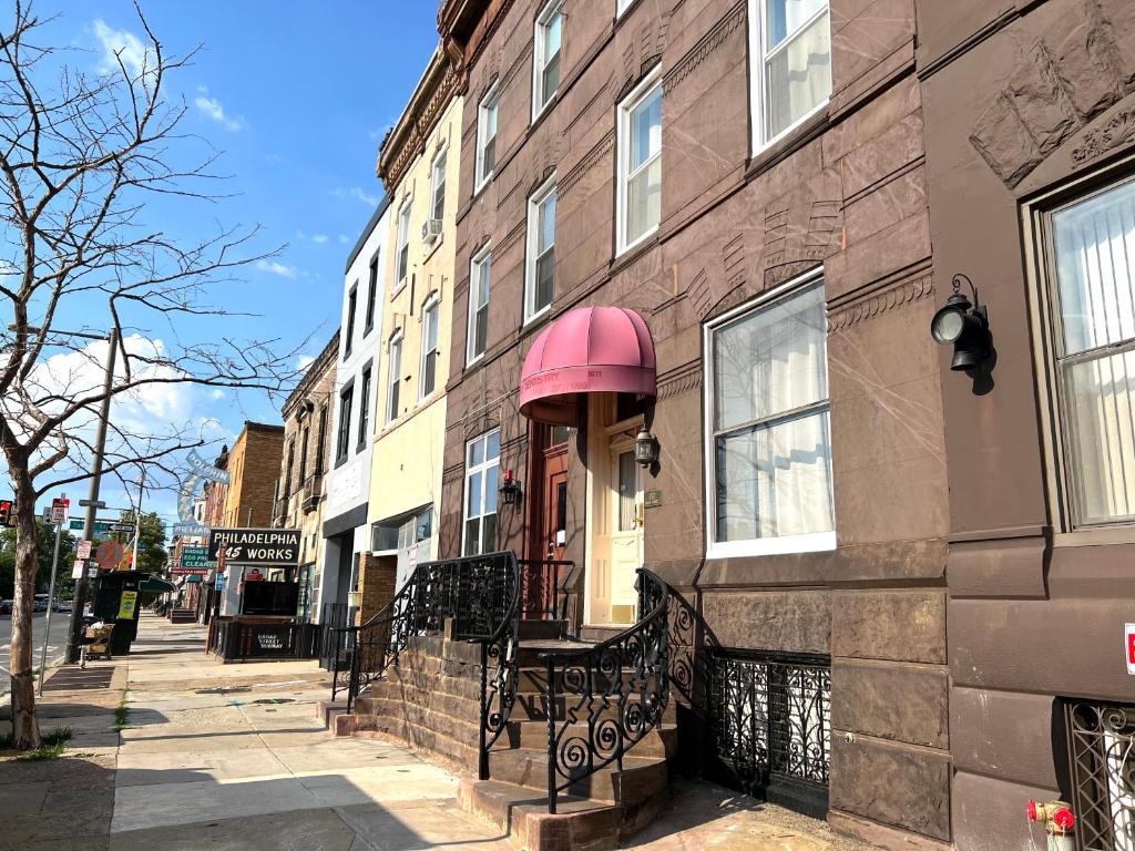 a building on a street with a pinkozyermottermottermott at Alina & Fanny - Philadelphia S Broad St in Philadelphia
