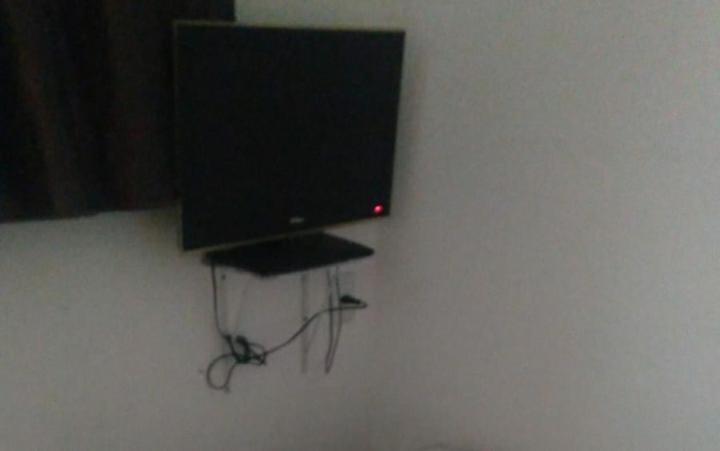 a flat screen tv sitting on a wall at Pousada Landus in Sao Paulo