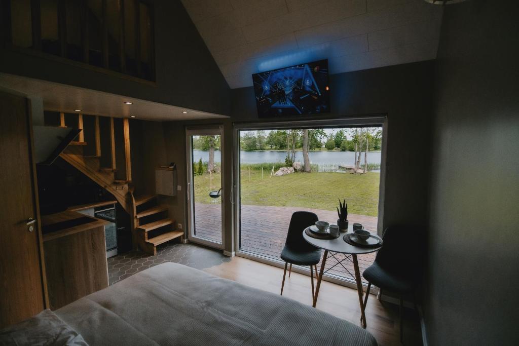 a bedroom with a bed and a table and a sliding glass door at Auksi puhkemaja-1 in Auksi