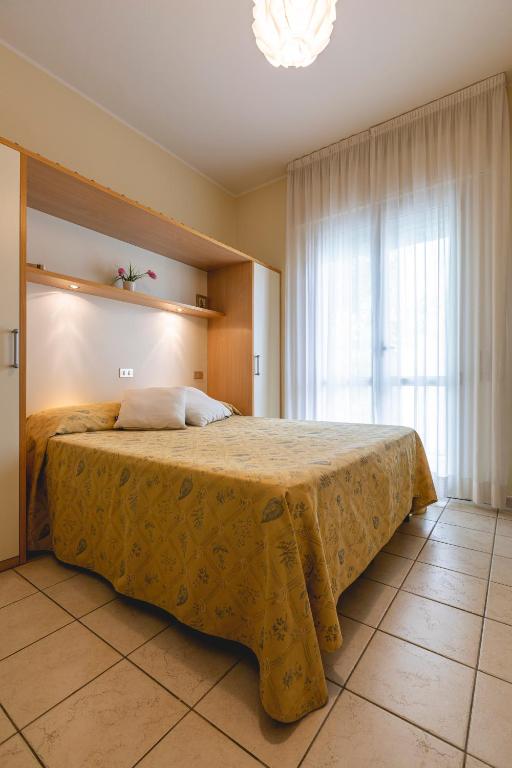 Postel nebo postele na pokoji v ubytování Hotel Loretta & Dependance