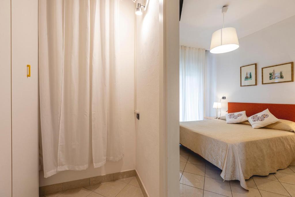Postel nebo postele na pokoji v ubytování Hotel Loretta & Dependance