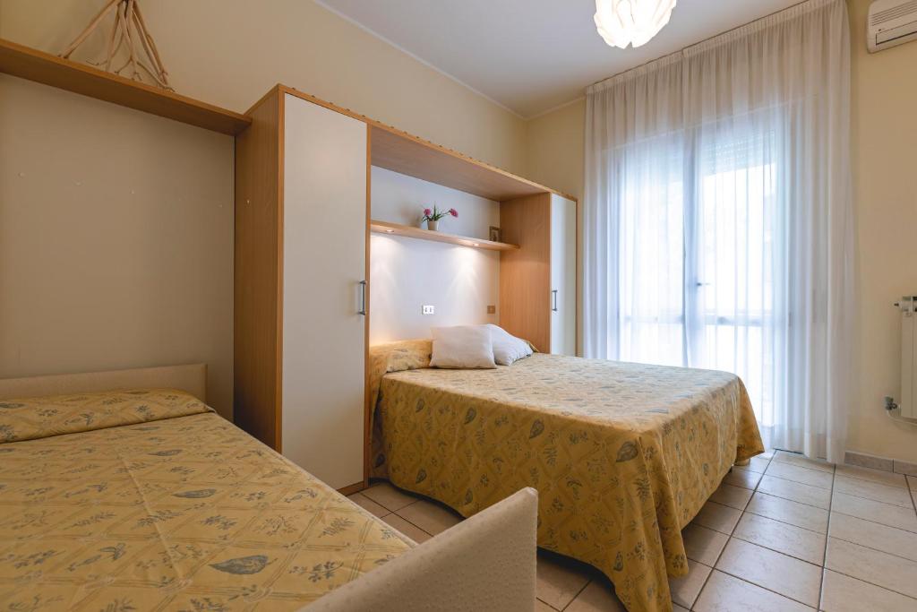 Postel nebo postele na pokoji v ubytování Hotel Loretta & Dependance