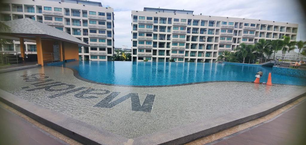 a heart shaped pool in front of a hotel at Laguna Beach Resort3 in Jomtien Beach