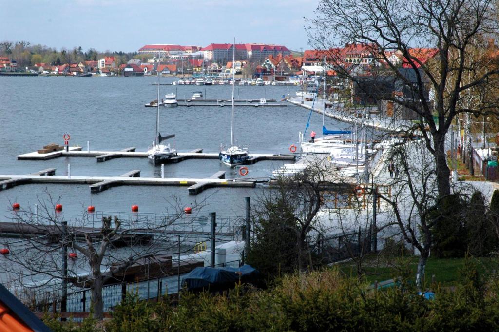 a group of boats docked at a marina at Trzy Żagle in Mikołajki