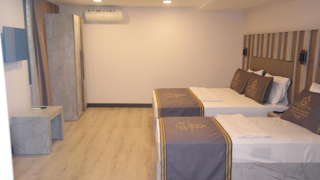 a room with two beds and a wall at ByAKKAN HOTEL in Bodrum City