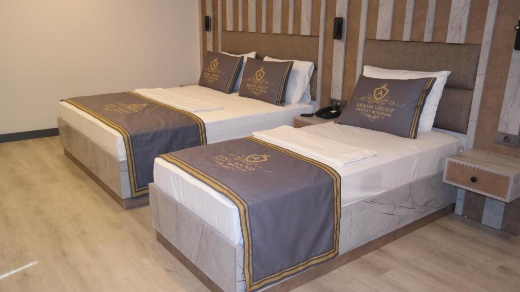 two beds sitting in a room with at ByAKKAN HOTEL in Bodrum City